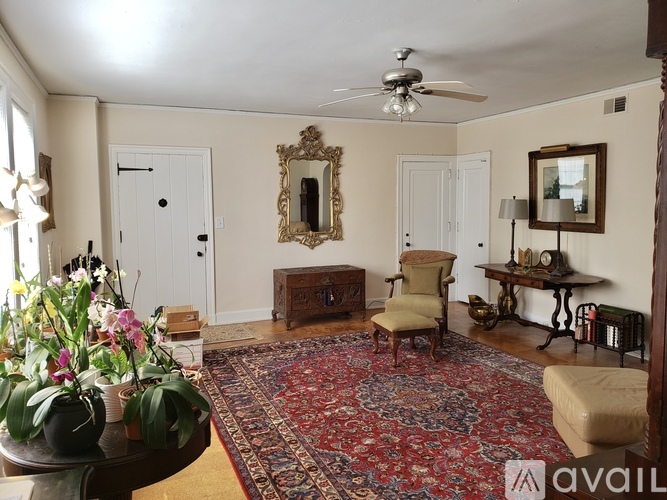 A room with wooden flooring and a large window.