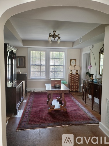 A room with wooden flooring and a ceiling fan.