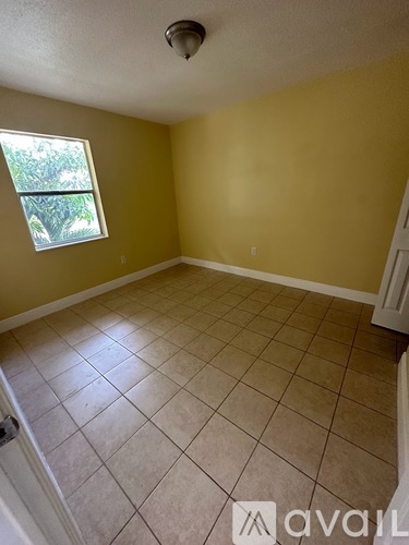 A room with yellow walls and a window.