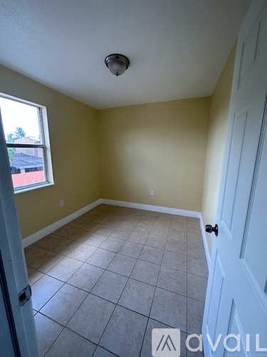 A room with a tiled floor and a ceiling fan.