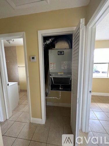A small kitchen with a refrigerator and a white cabinet.