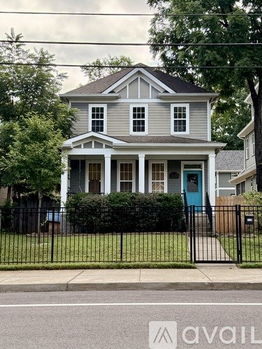 A house with a blue door is for sale.