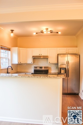 A kitchen with a stove top oven and a refrigerator.