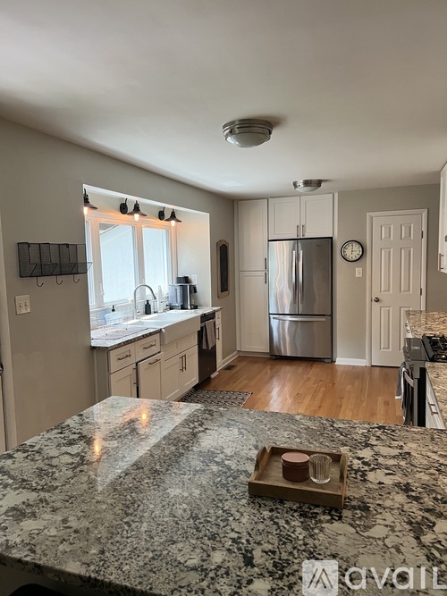 A kitchen with granite countertops and stainless steel appliances.