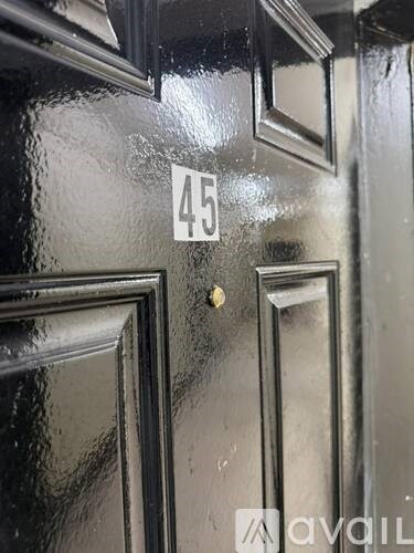 A black door with a number 45 on it.
