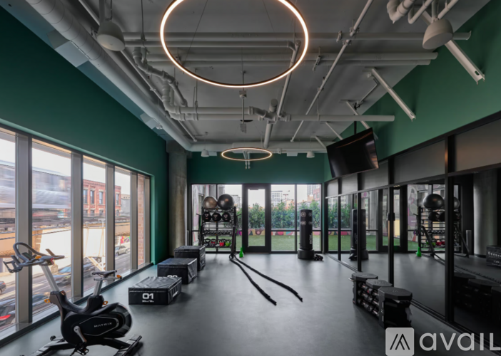 A gym with a view of the city outside the windows.