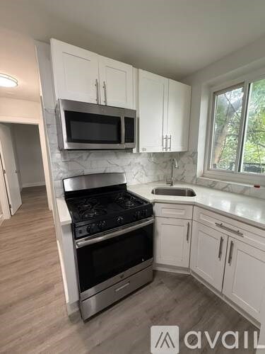 A kitchen with a stove top oven and microwave above it.