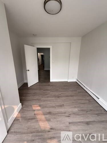 A room with a wooden floor and white walls.