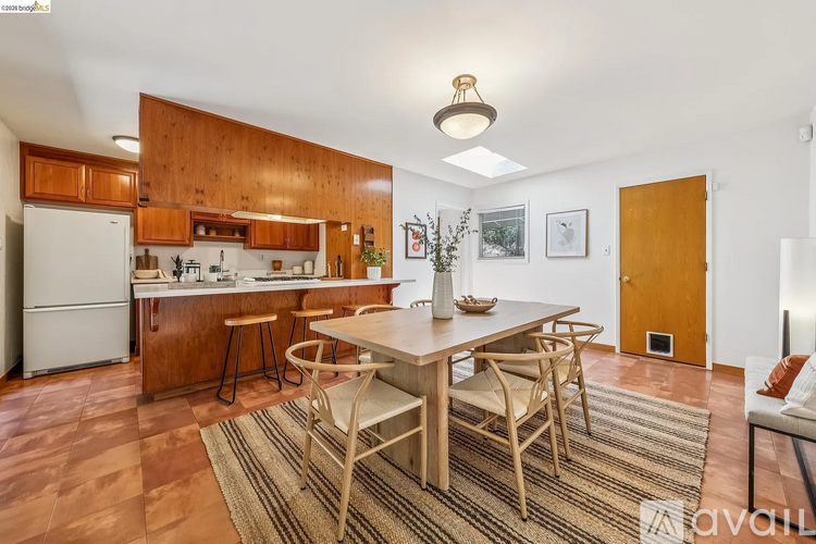 A kitchen with wooden cabinets and a white refrigerator.