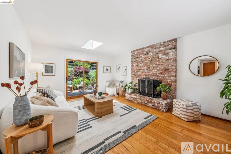 A living room with a fireplace and a large window.