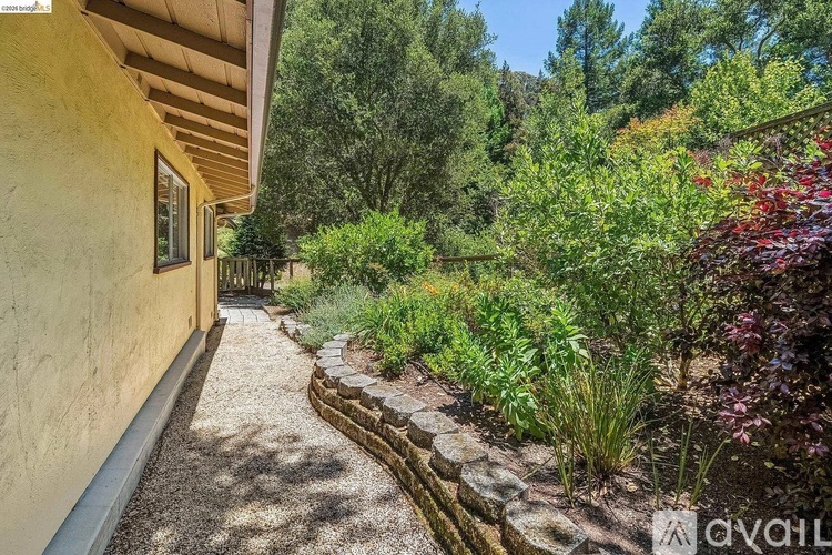 A garden pathway leads through a landscaped yard.