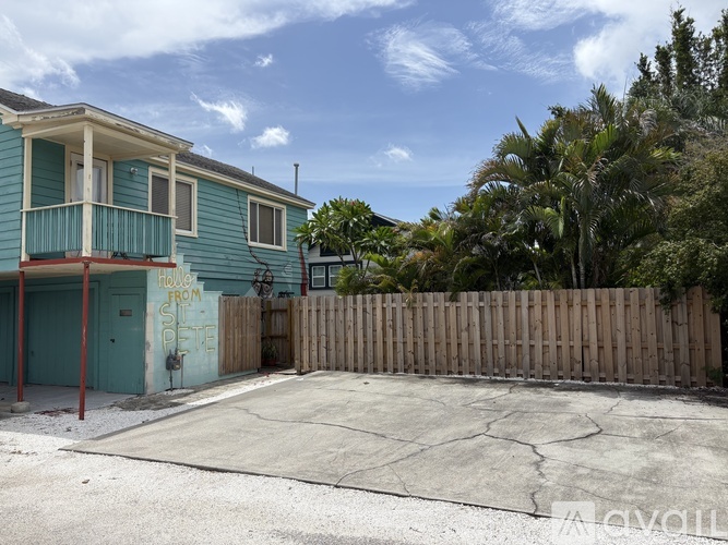 A blue house with a fence and a sign that says "HOUSE FROM THE".
