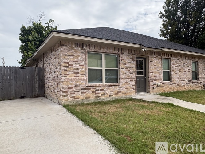 A house with a grey roof and a stone wall.