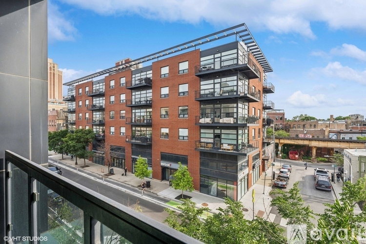A modern multi-story building with a mix of brick and glass facades.