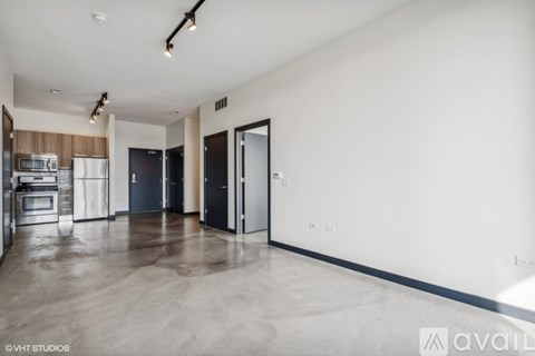 A spacious kitchen with dark wood cabinets and a white wall.