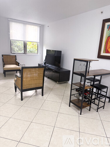 A living room with a chair, a sofa, a television and a shelf.