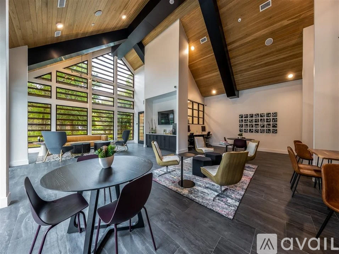 A modern living room with a large table and chairs.