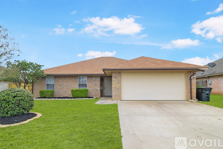 A house with a brown roof and a white garage door.