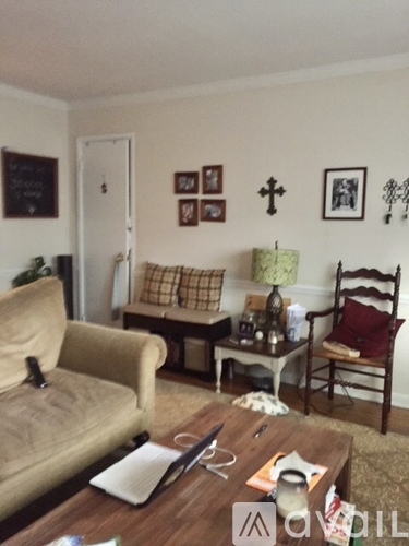 A living room with a couch, chair, and coffee table.