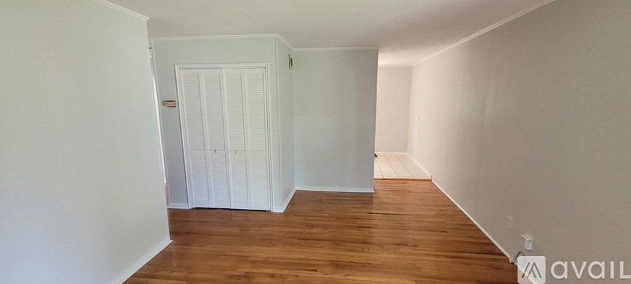 A room with wooden floors and white walls.
