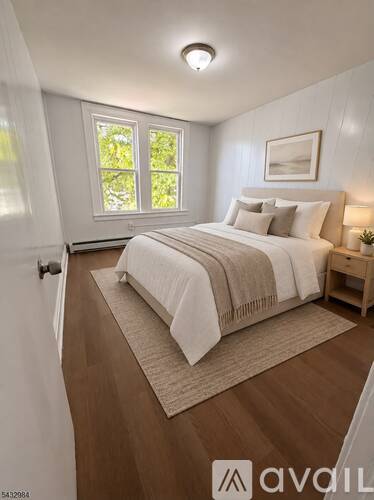 A bedroom with a large bed and a window.