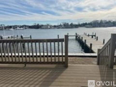 A wooden dock extends into a calm body of water.