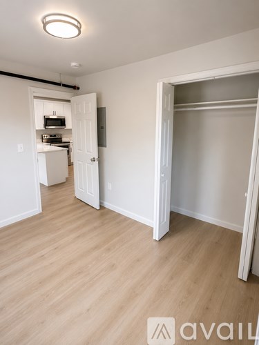 A room with a white door and a white wall.