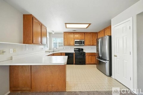 A kitchen with wooden cabinets and a white countertop.