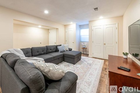 A living room with a grey sofa and a wooden coffee table.