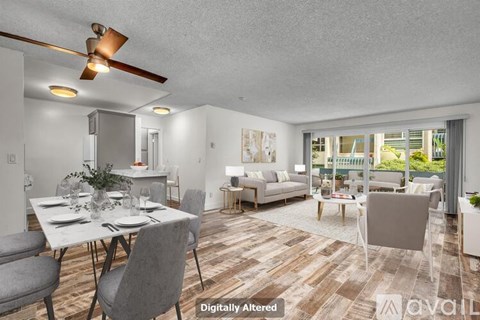 A digitally altered image of a modern dining room with a table set for two and a view of the backyard through the sliding glass doors.