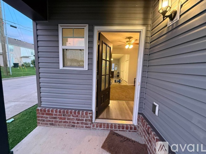A house number 7 with a door open and a mat on the floor.