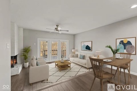 A living room with a fireplace and a dining table set up.