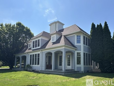A house with a large front porch and a chimney is for sale.