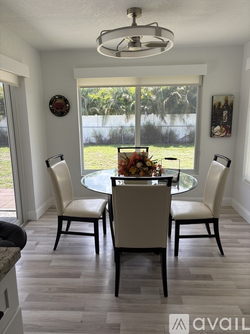 A dining room with a table set for four.