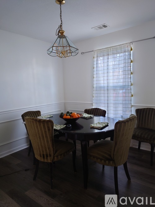 A dining room with a table set for four.