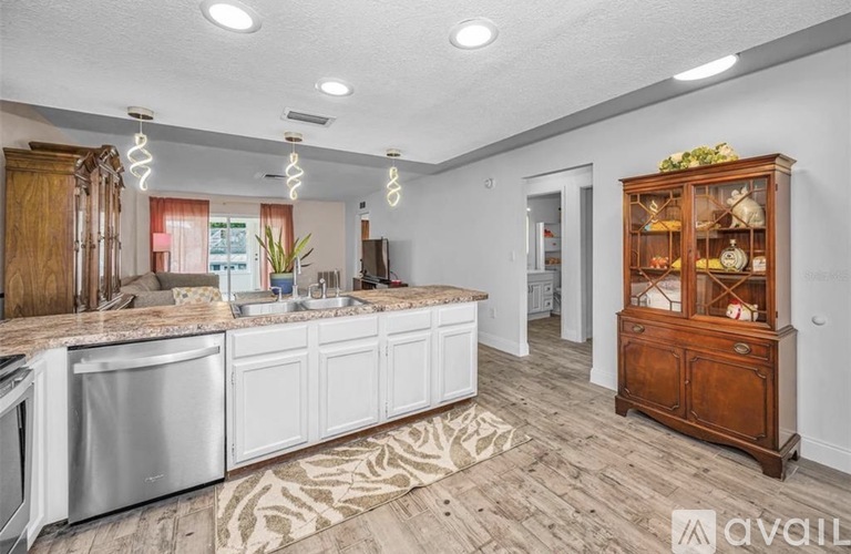 A kitchen with white cabinets and a wooden hutch.