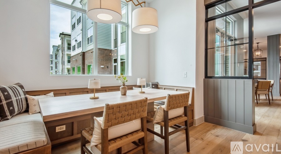 A modern dining room with a wooden table and chairs.