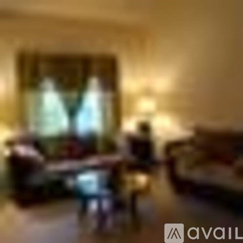 A blurry image of a living room with a couch and a table.
