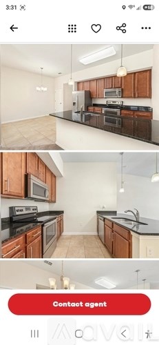 A kitchen with brown cabinets and black countertops.