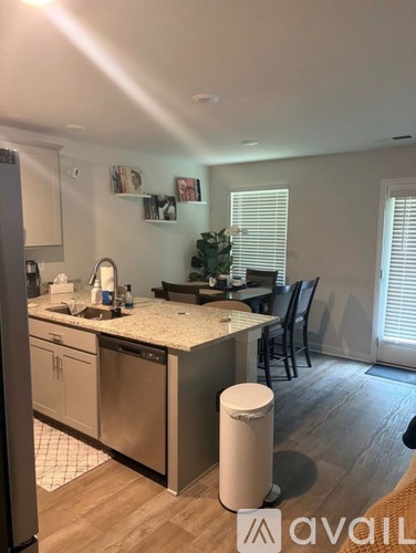 A kitchen with a white countertop and a stainless steel dishwasher.
