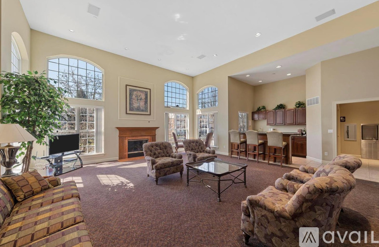A living room with a fireplace and a large painting on the wall.