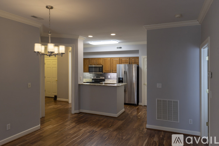 A kitchen with a refrigerator, microwave, and oven is available for rent.
