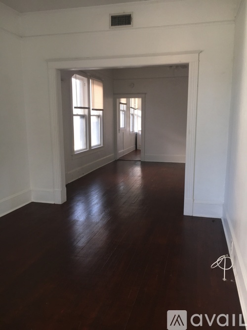 A room with wooden floors and white walls.