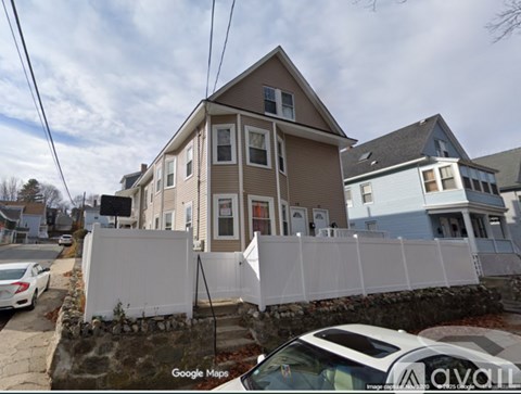 A white car is parked in front of a house with a Google Maps logo on the bottom left.