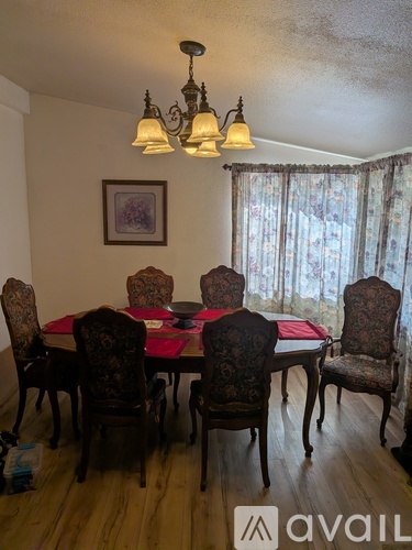 A dining room with a table set for four.