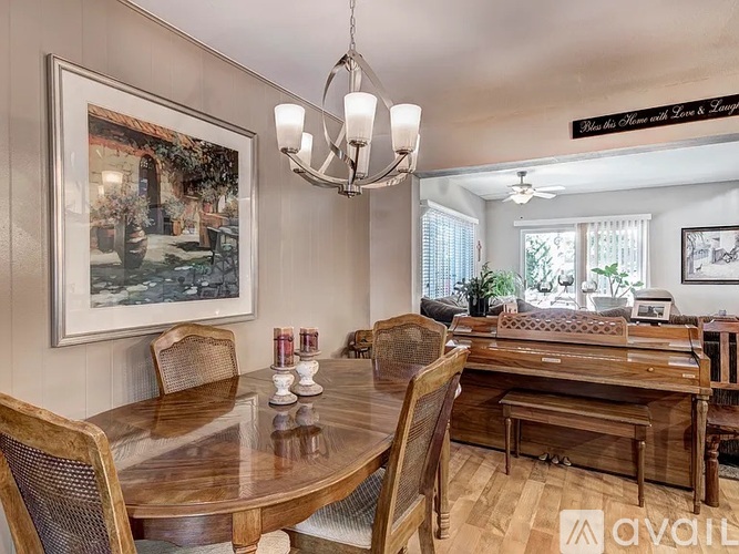 A dining room with a wooden table and chairs.