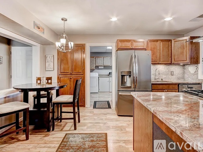 A kitchen with a table and chairs in the middle of the room.