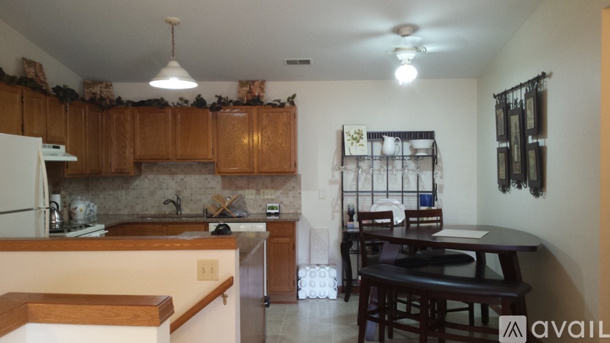 A kitchen with wooden cabinets and a black table.