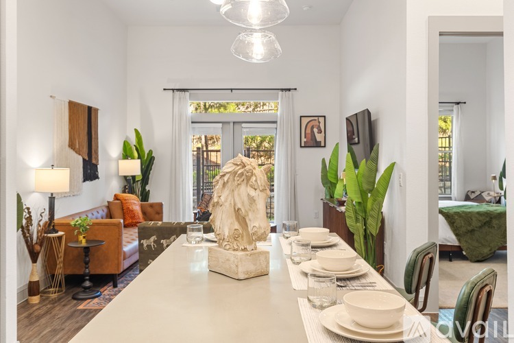 A dining room with a long table set for a meal.