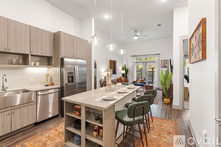 A kitchen with a table and chairs in the middle of the room.